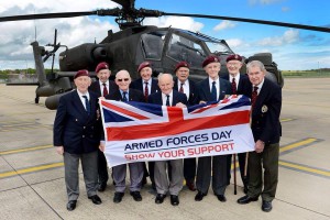 Veterans holding Armed Forces Day banner