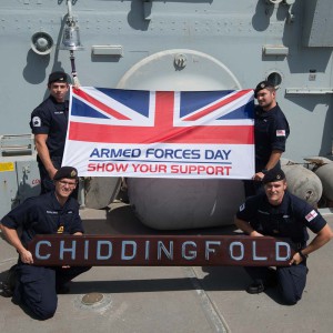 Crew of HMS Chiddingfold, a minehunter based in Bahrain, pose with the AFD flag