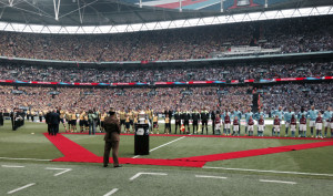 Sergeant Dipprasad Pun bringing the FA Cup on to the pitch