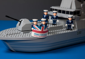 A toy model Type 45 destroyer and figures of Royal Navy sailors for Armed Forces Day an promotion shot. Armed Forces Day is an opportunity to do two things. Firstly, to raise public awareness of the contribution made to our country by those who serve and have served in Her Majesty's Armed Forces, Secondly, it gives the nation an opportunity to Show Your Support for the men and women who make up the Armed Forces community: from currently serving troops to Service families and from veterans to cadets
