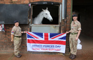 Defence Animal Training Regiment (DATR) Staff celebrating Armed Forces Day with the Armed Forces Day Flag at Remount Barracks.