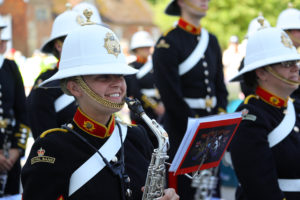 Members of the Military band playing at a Armed Forces Day parade. 