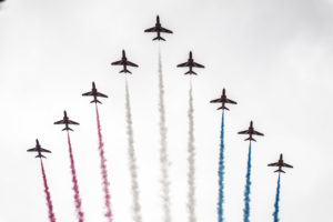 Red Arrows flying in formation with the colour smoke. 