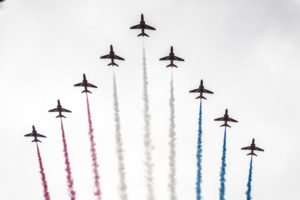 Red Arrows flying in formation with the colour smoke.