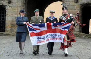 Image of Armed Forces personnel with flag