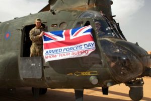 Armed Forces personnel holding the Armed Forces day flag