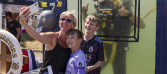 A family pose with a Royal Navy Diver at Armed Forces Day in Falmouth.